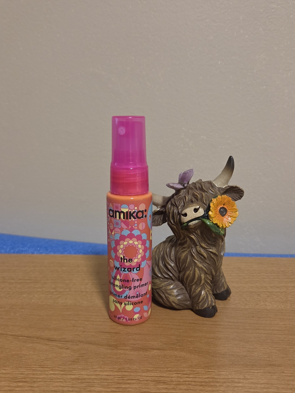 amika detangling primer spray in pink and orange bottle